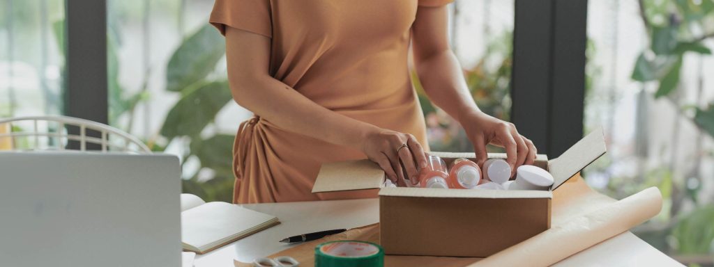 Mujer colocando envases de plástico en una caja